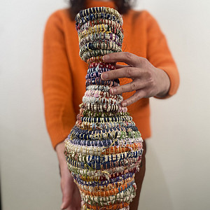 A vase made out of woven fibers.