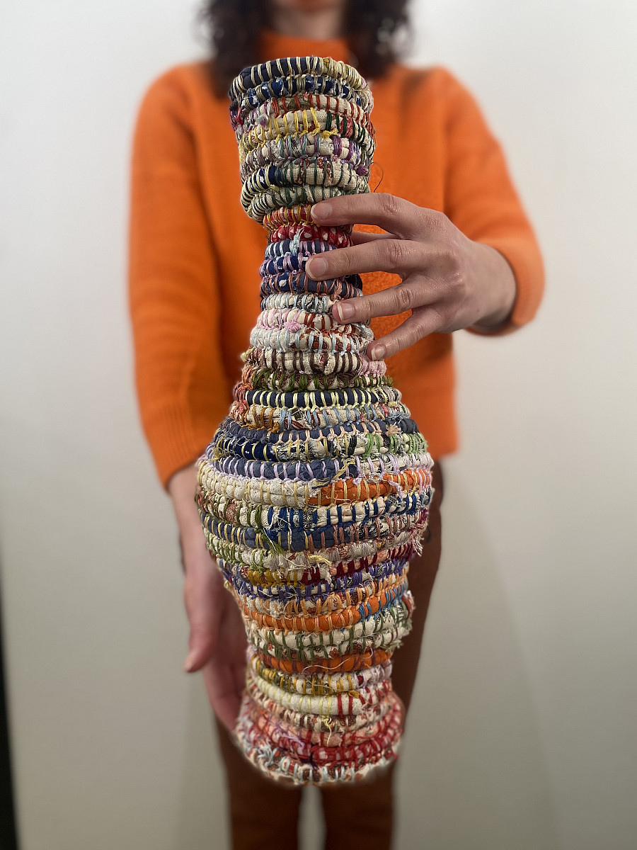 A vase made out of woven fibers.