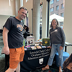 The graduate school dean and secondary MAT program director welcome visitors to the reading corner.