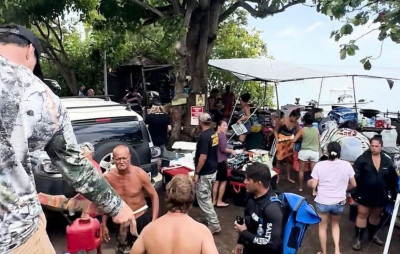 Residents unload supplies received from local fishing boats. Roads were blocked and supplies were taken to locals by locals on personal boat