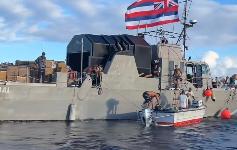 A fishing boat arrives from O'ahu, bringing supplies donated directly from the people of O'ahu.
