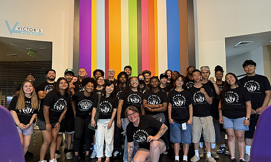 Group of people wearing matching black tshirts.